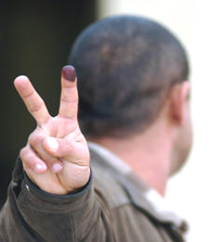 An Iraqi voter's purple finger (Source: Department of Defense)
